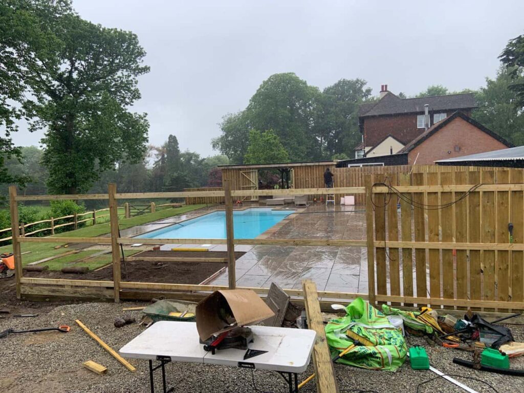 This is a photo of Bespoke custom fencing installed around a swimming pool by Fast Fix Fencing Downham Market