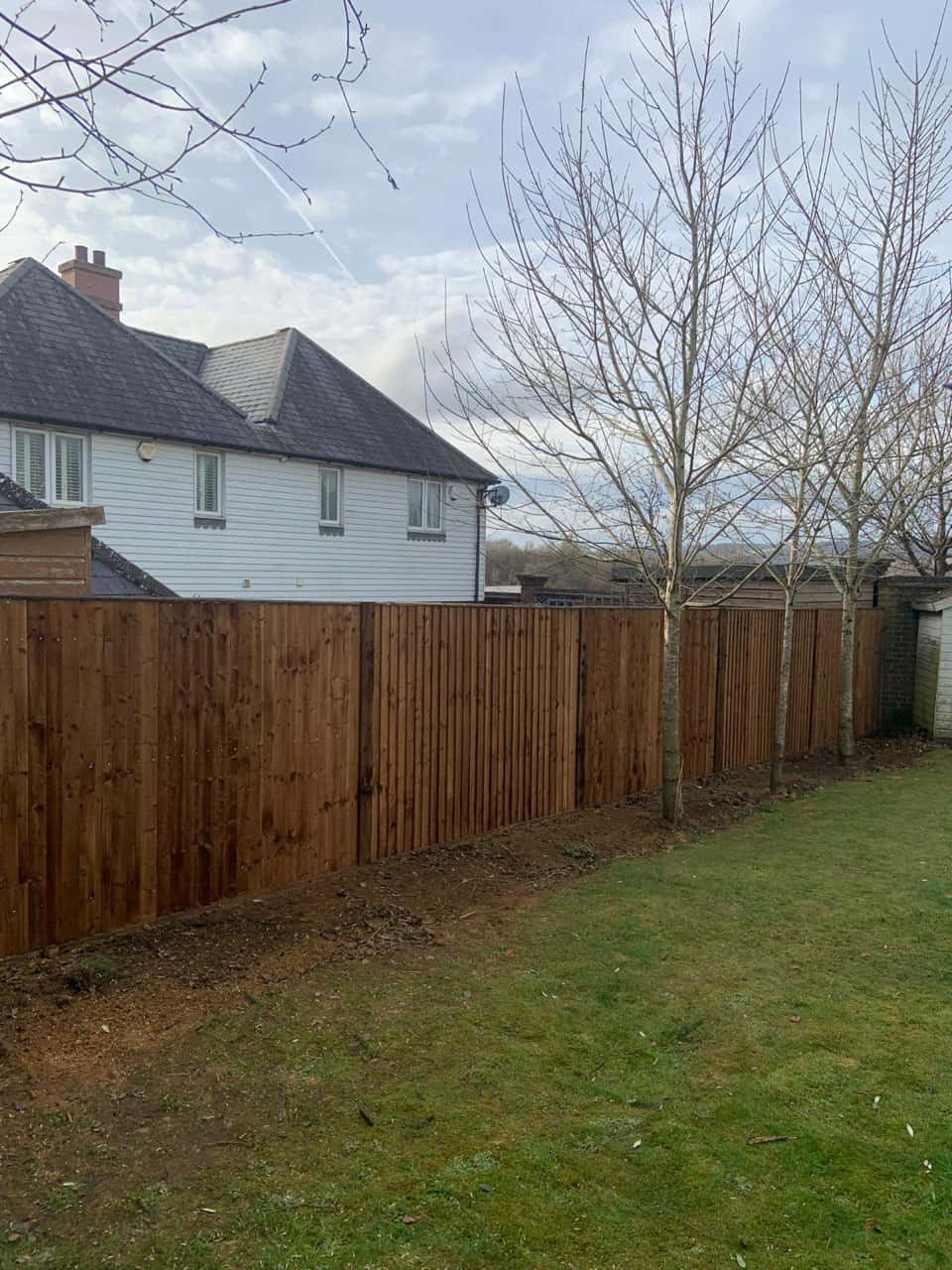 This is a photo of feather edge fencing installed in a residential properties garden by Fast Fix Fencing Downham Market